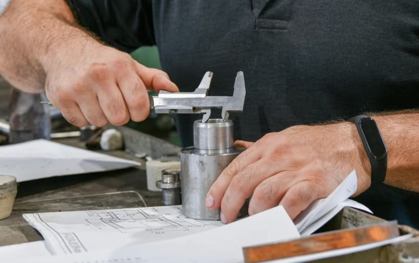 Engineers check whether the CNC parts are qualified.
